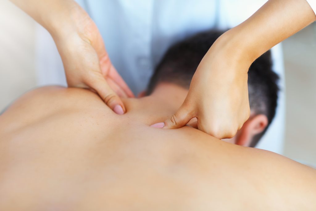 Handsome man having massage in spa salon